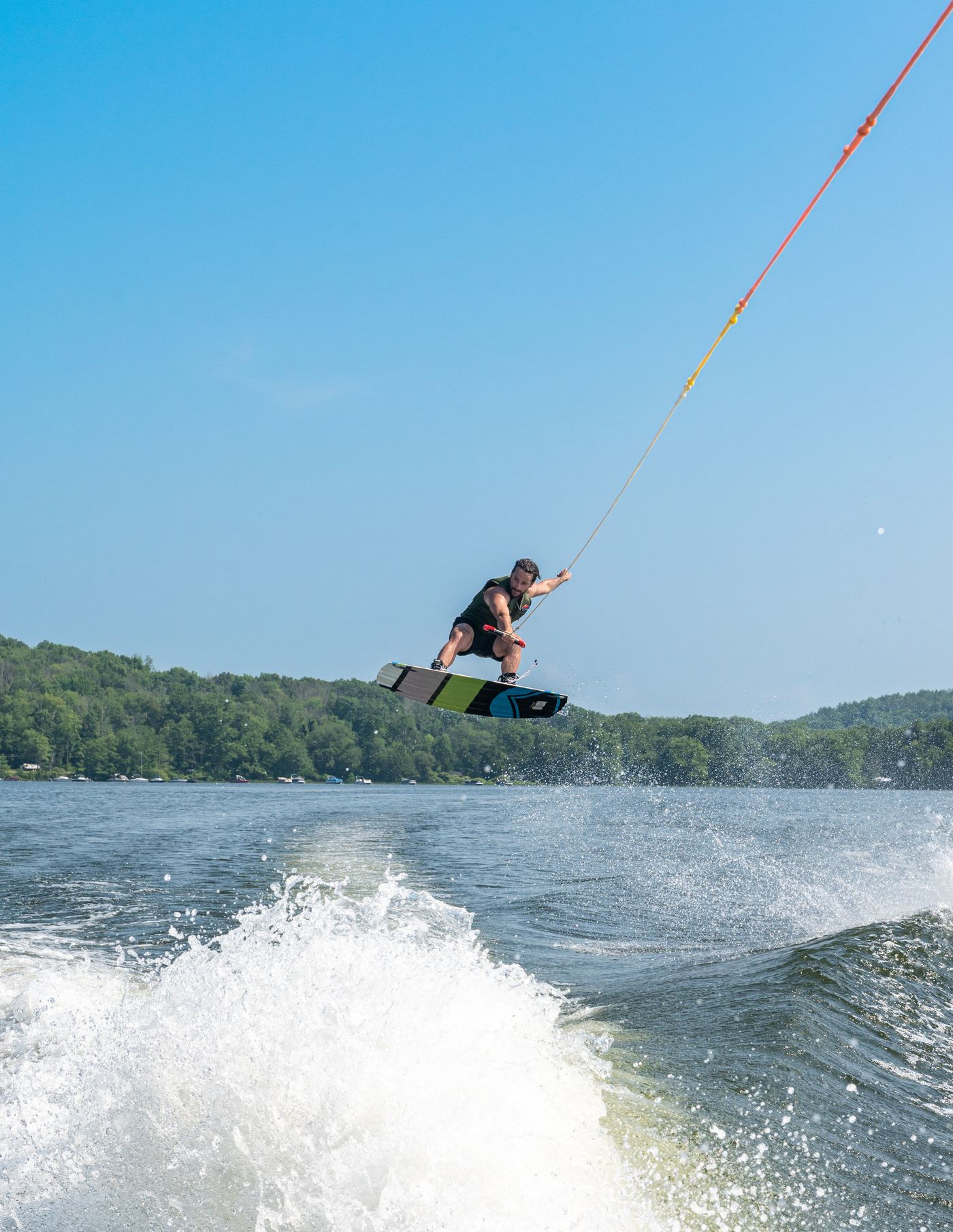 A rider launching off the wake behind a ski boat on a Connecticut lake