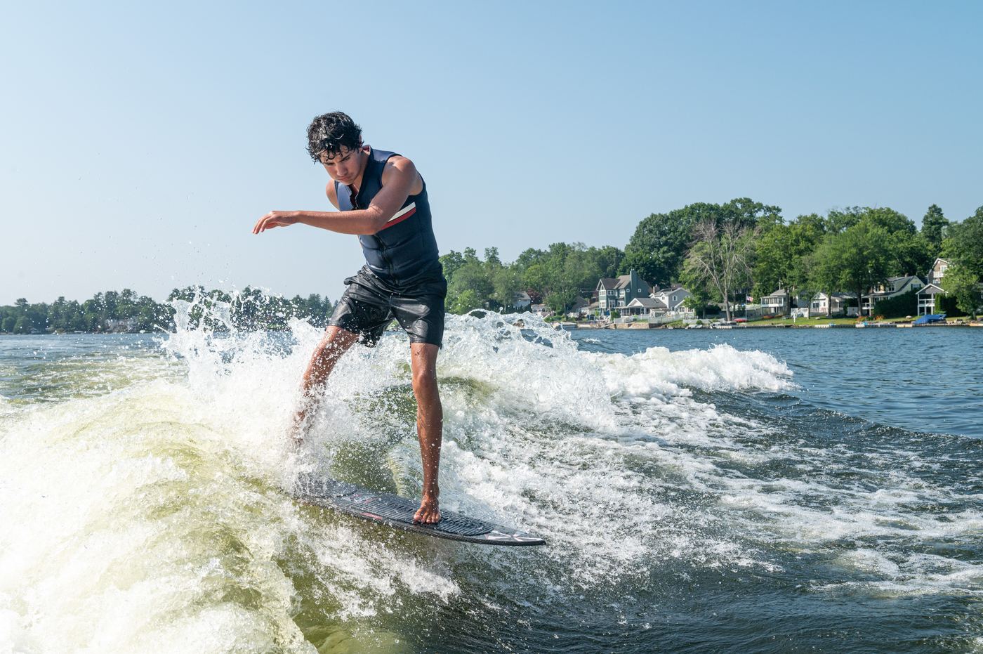 Wakesurfer riding behind a CT Water Sports boat
