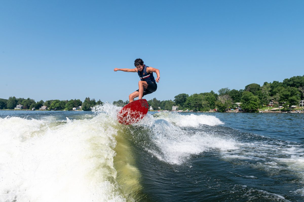 A guest wakesurfing in the boat's wake