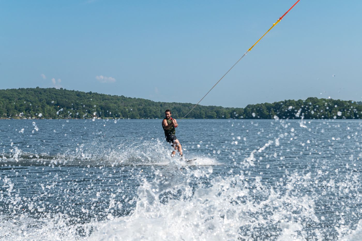 Skier wearing a Type III flotation aid being towed on a Connecticut lake